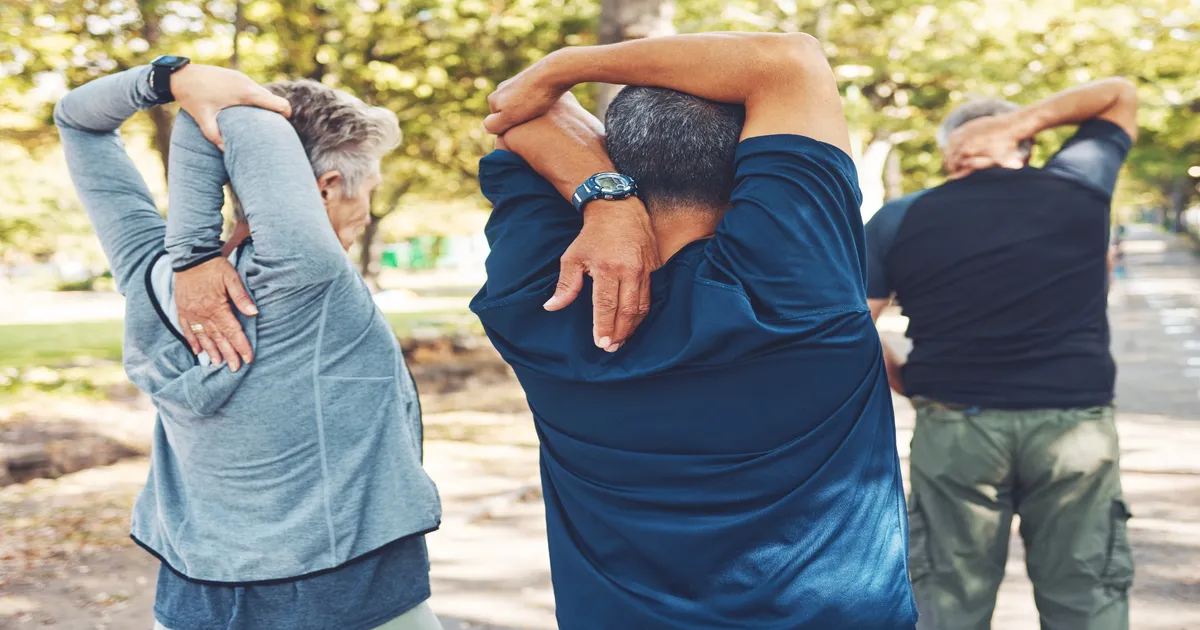 Senior individuals stretching outdoors, promoting back pain relief and active lifestyles.